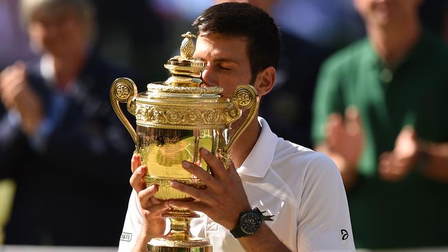 Serbia's Novak Djokovic kisses the winners trophy.