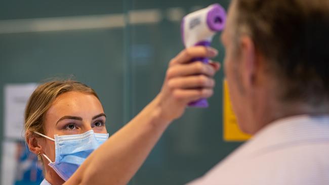 Registered Nurse Grace Heidke (24) from Cromer taking the temperatures of everyone arriving at Northern Beaches Hospital in Frenchs Forest on 23rd April 2020. (AAP Image / Julian Andrews).