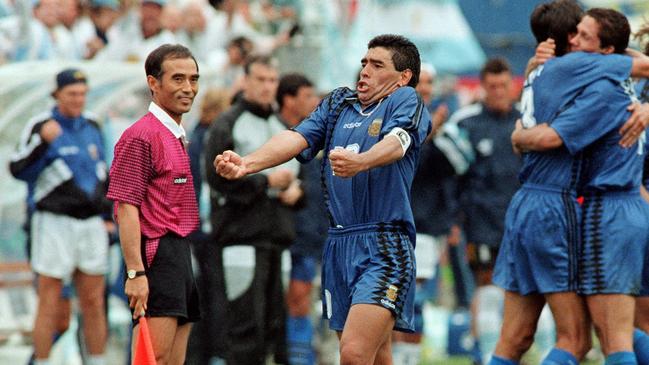 Even the linesman has a bit of a chuckle at Diego Maradona’s antics.