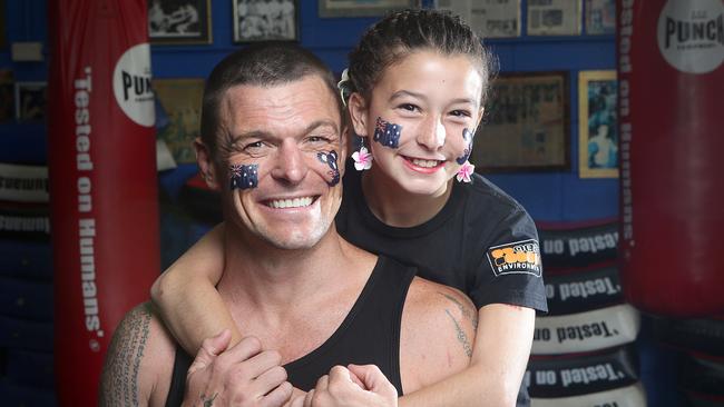 John Wayne Parr and his 12-year-old daughter Jasmine, wearing the Gold Coast Bulletin Australia Day Tattoos. Picture: Jono Searle.