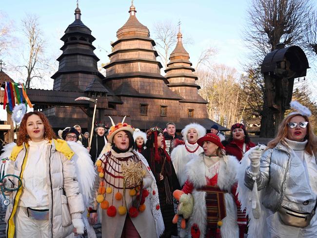 People dressed in costumes sing carols to celebrate in Lviv. Picture: AFP