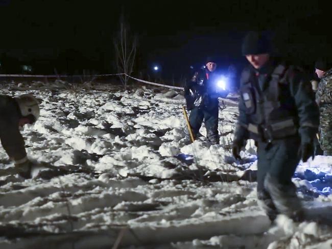 Russian Emergency Situations Ministry employees work at the scene of a AN-148 plane crash in Stepanovskoye village, about 40km from the Domodedovo airpor. Picture: RMES/AP