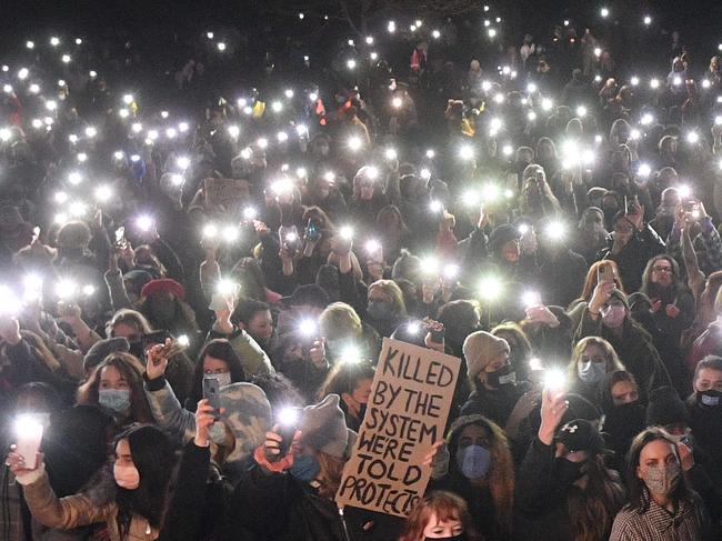 Well-wishers turn on their phone torches as they gather at a vigil in honour of Sarah Everard last March. Picture: AFP