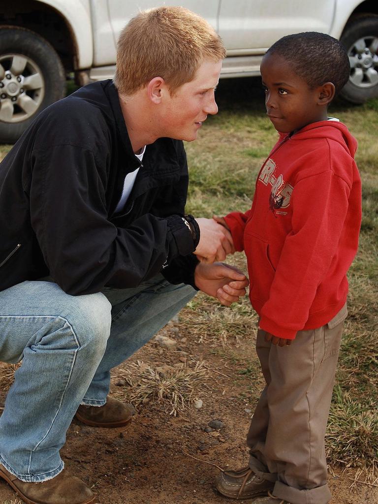 Prince Harry shakes hands with Mutsu Potsane in the grounds of the Mants’ase children’s home while on a return visit to Lesotho on April 24, 2006 in southern Africa. Picture: Getty