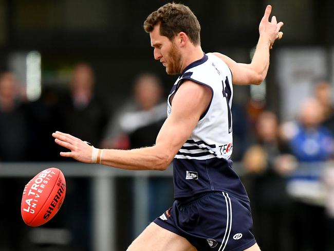 Peter Mcevoy of Bundoora kicks during the round 13 Northern Football Netball League 2023 Melbourne Greyhounds Division 1 Seniors match between Bundoora and Montmorency at Yulong Reserve in Bundoora, Victoria on July 15, 2023. (Photo by Josh Chadwick)