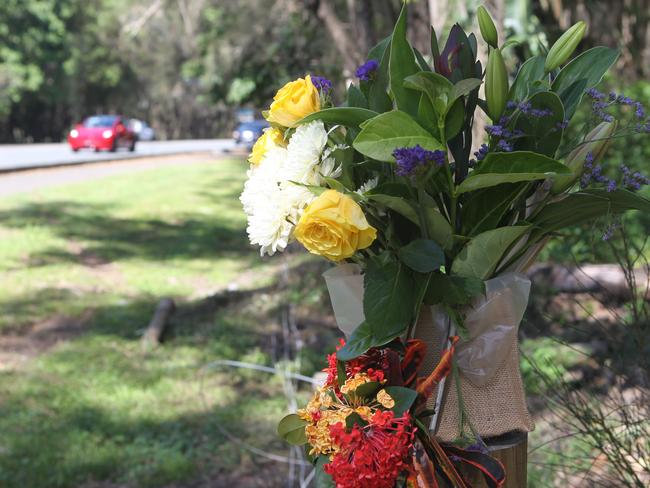 Floral tributes at the scene of the crash that killed a nine-year-old boy at Robina Town Centre Drive on Wednesday. Picture: Richard Gosling.