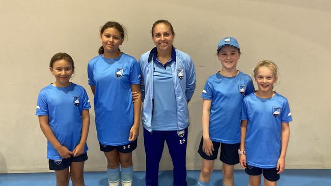 Stars of the future. Sydney FC and Matildas midfielder Mackenzie Hawkesby with her all-girls team at a recent Sydney FC holiday clinic. Photo: Kevin Merrigan