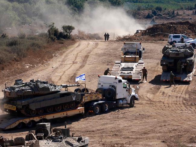 An Israeli tank is transported to a position in the Upper Galilee region of northern Israel near the border with Lebanon. Picture: AFP