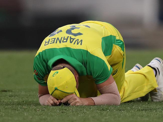 Australia's David Warner injures himself fielding a ball during the One-Day International cricket match between Australia and India at the SCG. Picture: Brett Costello