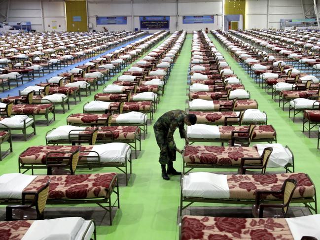 A member of the Iranian Army works at a temporary hospital in Tehran, Iran. Picture: AP