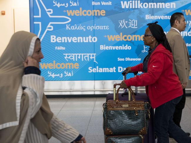 Travellers arrive at the international terminal at John F. Kennedy International Airport. Picture: Getty