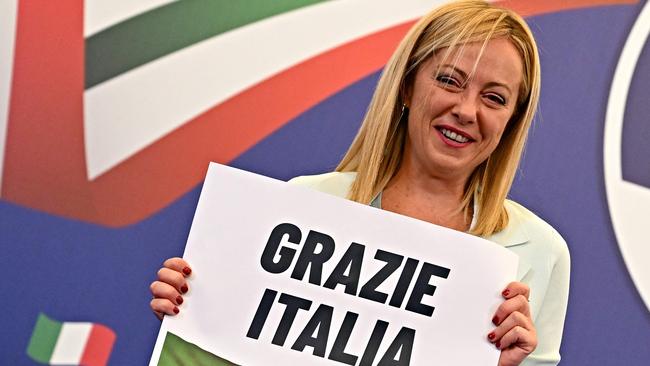 Leader of Italian far-right party Brothers of Italy Giorgia Meloni holds a placard reading "Thank You Italy" after an address at her party's campaign headquarters. Photo: Andreas Solaro