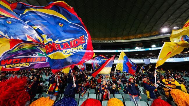 The Adelaide Crows cheer squad stand apart during the game on Monday night. Picture: Daniel Kalisz / Getty Images