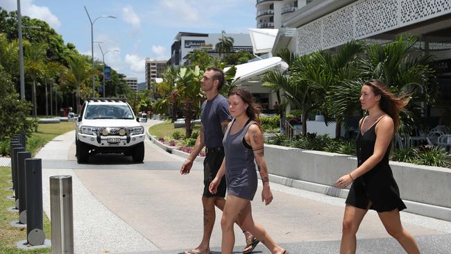 Dean Esperance, La Woolbank and Wanda Weigand, all of Aeroglen, attempt to cross the shared zone, where the 20km/h speed limit is seldom observed. Picture: Brendan Radke