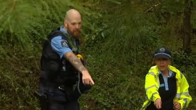 NSW Police officers find the bodies of a man and woman who went missing in flood waters at Wentworthville on Tuesday. Picture: 7 News