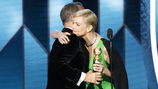 Tom Hanks accepting the Cecil B. DeMille Award from presenter Charlize Theron at the 77th Annual Golden Globe Awards Picture: AP