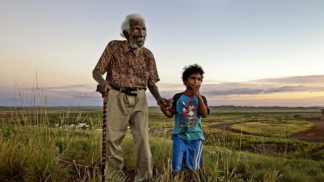 Manyarnbangu Ned Cheedy, 105, and his great grandson Will Woodley look out over the land from Mt. Welcome in Roebourne, WA. Picture: Lee Griffith