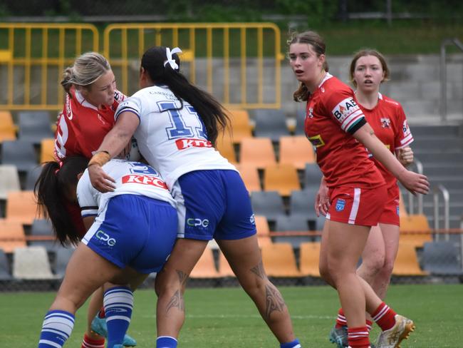 Katie Stevens is hit by Litia Fusi (left) and Noaria Kapua. Picture: Sean Teuma/NewsLocal