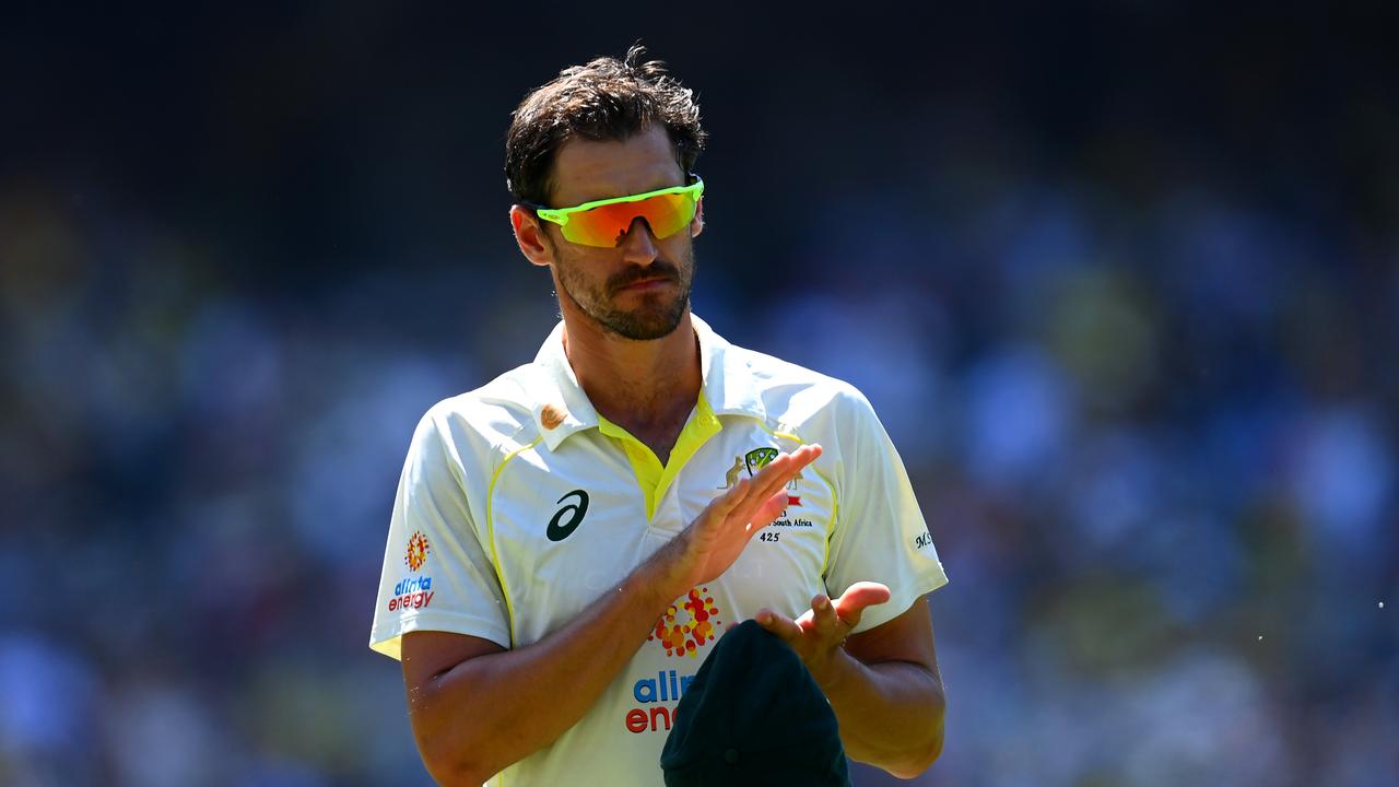 Mitchell Starc claps during the Shane Warne tribute.