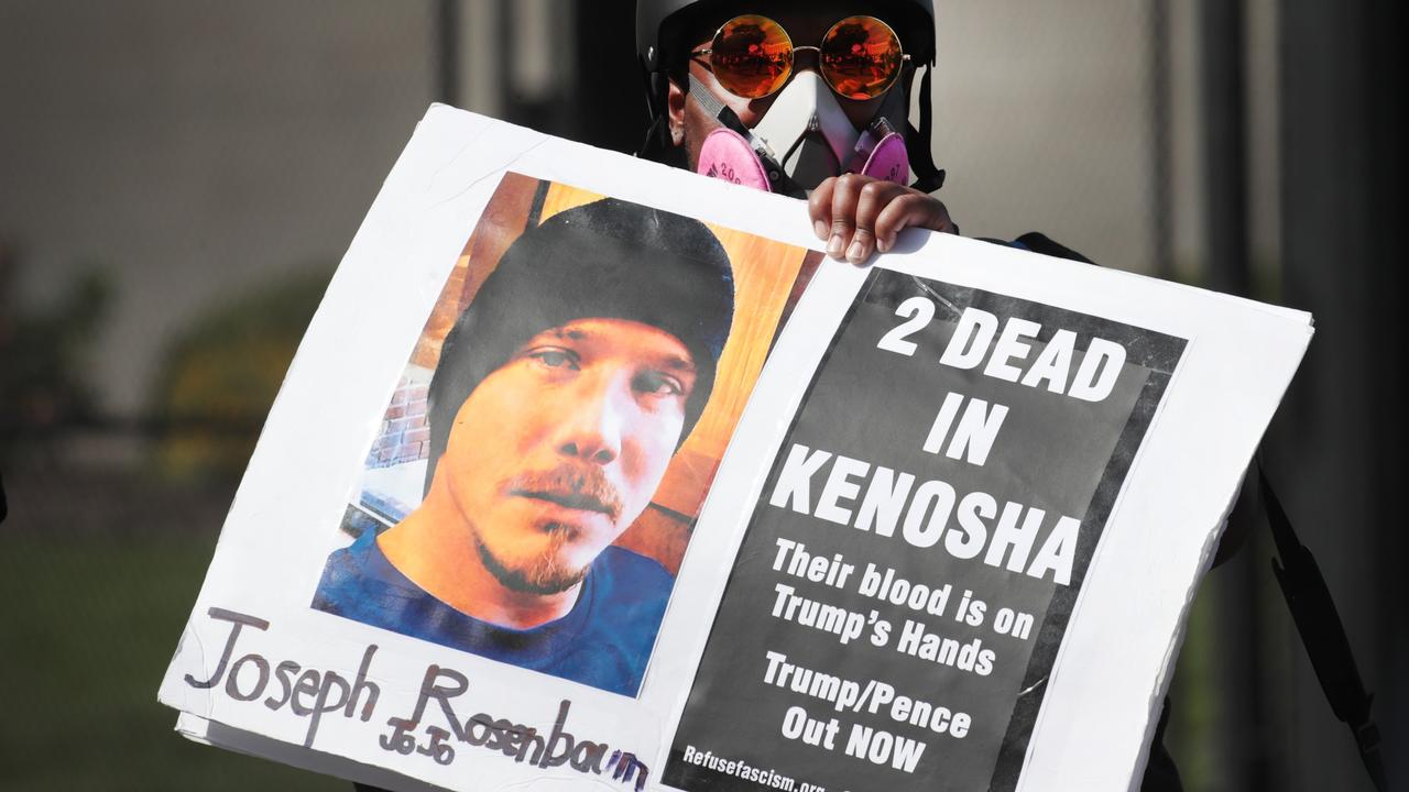 An activist holds a sign honouring Joseph Rosenbaum, one of two activists killed during demonstrations in Kenosha, Wisconsin. Picture: Scott Olson/Getty Images/AFP