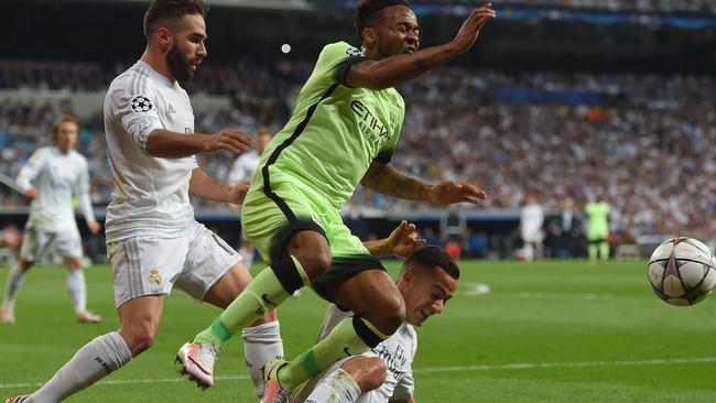 Raheem Sterling of Manchester City is tackled by Lucas Vazquez of Real Madrid.