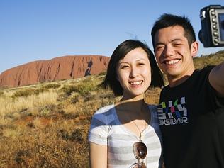 CHINA OUTBACK TOURISM .. Chinese female (25 years old) and Chinese male (25 years old) tourists at Uluru (Ayers Rock), UluruK...