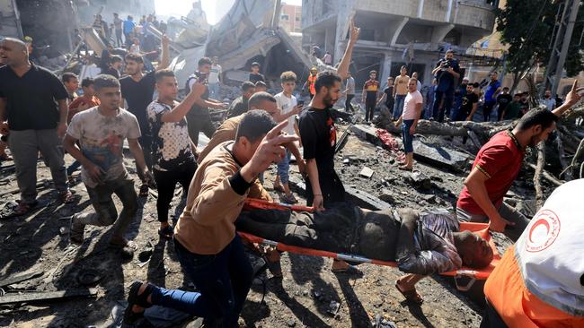 Palestinians evacuate a victim after an Israeli strike on a building in Khan Yunis in the southern Gaza Strip. Picture: Mahmud Hams/AFP