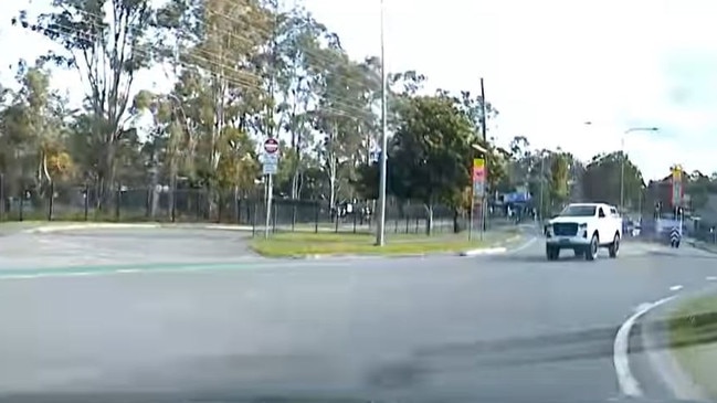 A ute pictured driving on the wrong side of the road outside Helensvale State High School. Picture: Monterey Keys Community Group / Facebook.