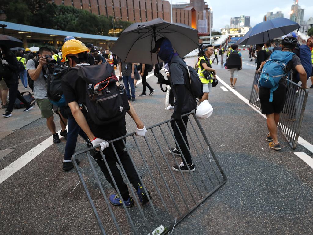Protesters drag metal barricades onto a highway during a demonstration in Hong Kong. Picture: AP