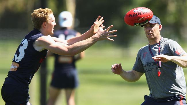 Clayton Oliver of the Demons gets the ball off head coach Simon Goodwin at training. Picture: Michael Dodge/Getty Images