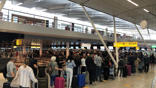 People queue at Amsterdam Schiphol Airport due to lack of employees and holiday season congestion. Picture: Getty