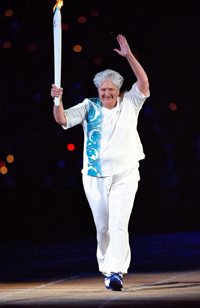 Torch Bearer Dawn Fraser of Australia acknowledges the crowd during the Opening Ceremony of the Sydney 2000 Olympic Games. Picture: Jamie Squire