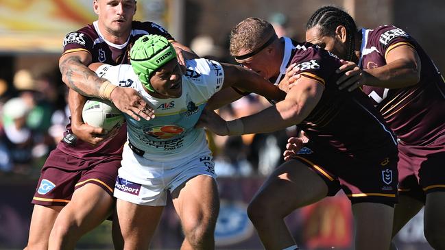 Cooper Bai of the Titans is tackled during the 2025 NRL Pre-Season Challenge match between Brisbane Broncos and Gold Coast Titans. Photo: Bradley Kanaris/Getty Images