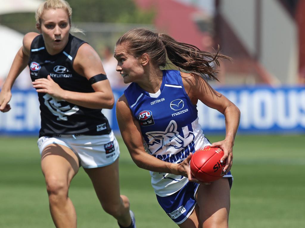 North Melbourne’s Ashleigh Riddell, right, being chased by Carlton’s Sarah Hosking, left, Picture: LUKE BOWDEN