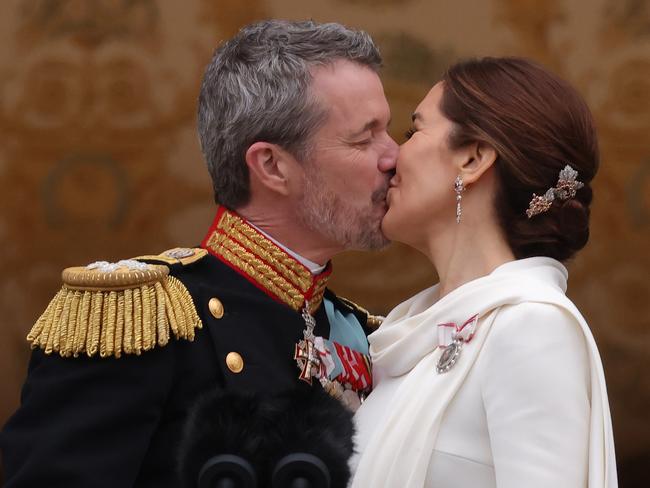 COPENHAGEN, DENMARK - JANUARY 14: Danish King Frederik and Queen Mary kiss on the balcony of Christiansborg Palace shortly after his proclamation on January 14, 2024 in Copenhagen, Denmark. King Frederik X is succeeding Queen Margrethe II, who has stepped down after reigning for 51 years. (Photo by Sean Gallup/Getty Images)