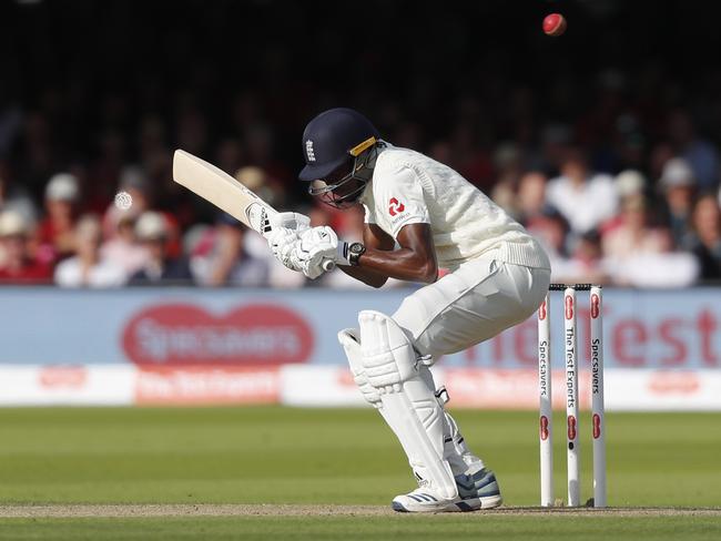 England's Jofra Archer ducks a bouncer off the bowling of Australia's Pat Cummins during the second day of the second Ashes test match between England and Australia at Lord's cricket ground in London, Thursday, Aug. 15, 2019. (AP Photo/Frank Augstein)