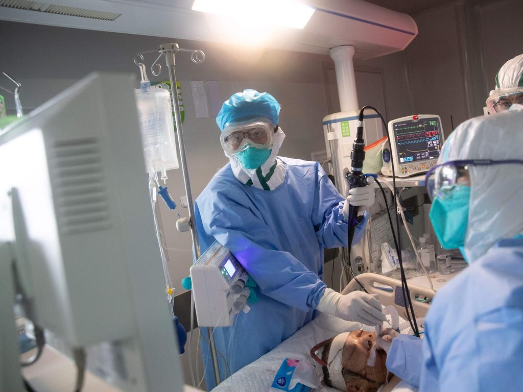 Medical staff treat a COVID-19 coronavirus patient at a hospital in Wuhan. Picture: STR / AFP