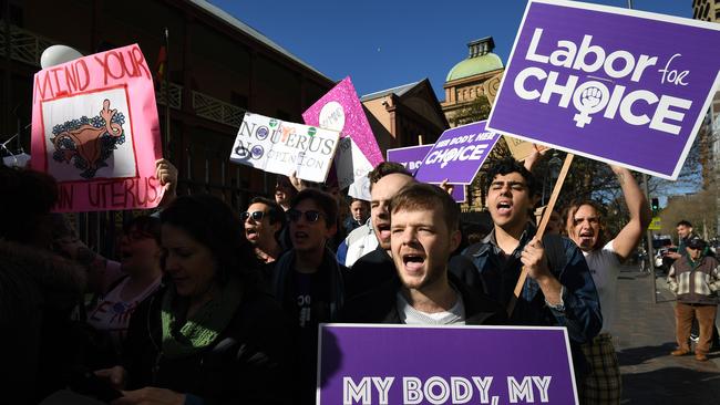 Pro-choice advocates hold placards during a rally outside the NSW parliament. Picture: AAP