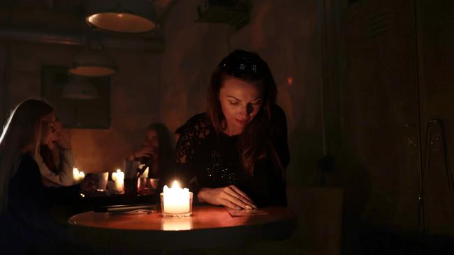 Ukrainians in a cafe without power in Lviv. Picture: Getty Images.