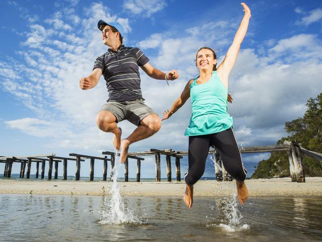 Tourists Jamen Gallagher 21, and Tess Schreck 28, at McKenzies Jetty on Fraser Island. Photo Lachie Millard