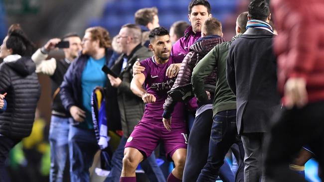 Sergio Aguero of Manchester City is involved in an altercation with fans.