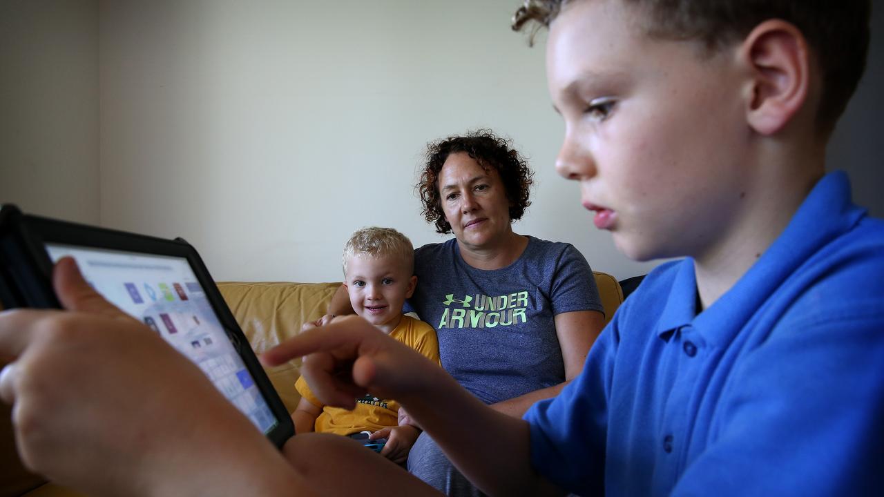 Frenches Forrest mum Susie Campbell, pictured in 2019 with sons Thomas (in blue) and Patrick, is concerned at the amount of fast food advertising that bombards social media while her sons are playing games or watching videos. Picture: Toby Zerna