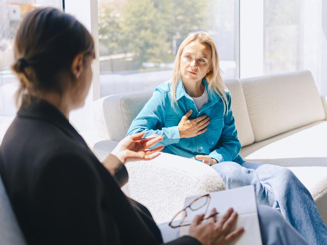 Two women sitting in armchairs and talking. Female coach, psychotherapist, psychologist, advisor and patient, client, psychotherapy. Pain and heartache