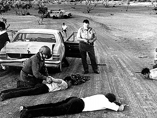 Police handcuffing three prison escapees who were captured on Birdsville Track on Sep 14 1970.  Men had taken Monica Schiller hostage after escaping from Cadell Training Centre.  kidnapping prison escapecrime 1970s