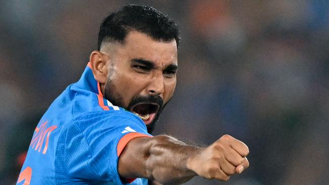 Mohammed Shami celebrates the wicket of David Warner. (Photo by Sajjad HUSSAIN / AFP)