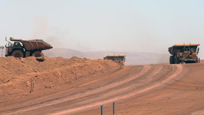 Autonomous haul trucks travels along a haul road at Rio Tinto Group's Gudai-Darri iron ore mine in the Pilbara region of Western Australia. Picture: Carla Gottgens/Bloomberg