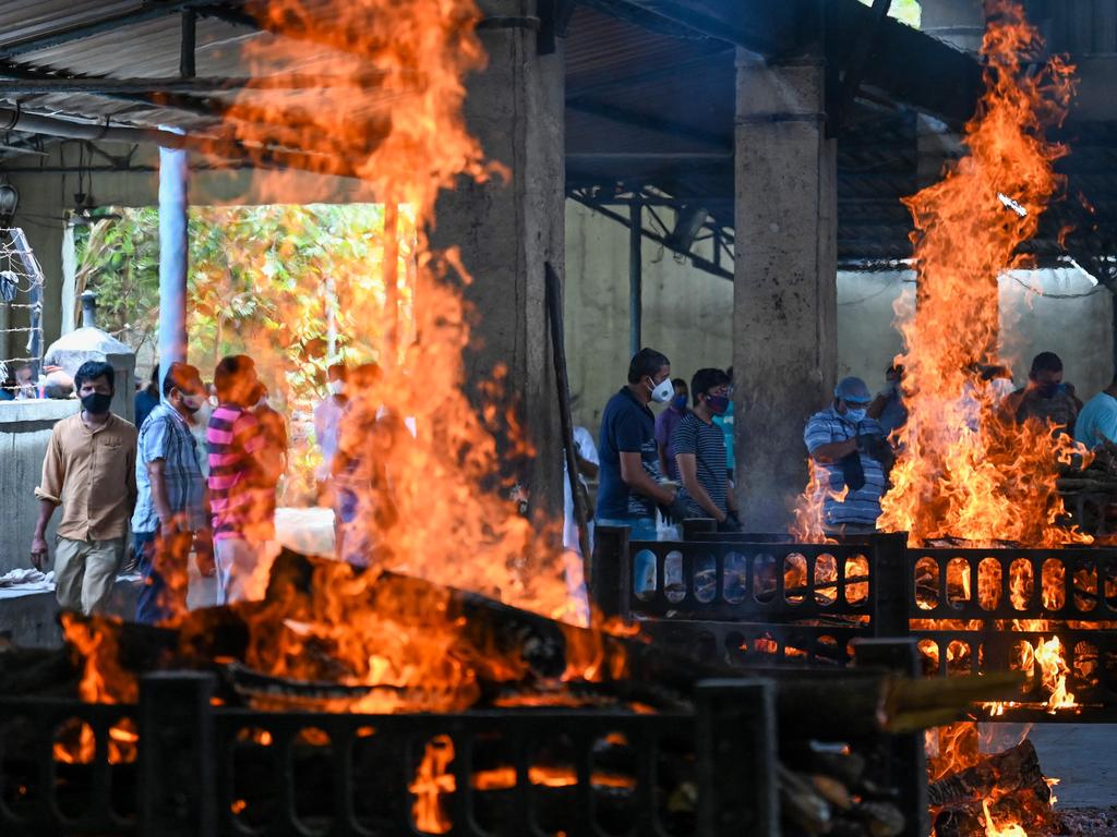 Relatives stand near the pyres of the COVID-19 victims. Picture: Punit Paranjpe/AFP