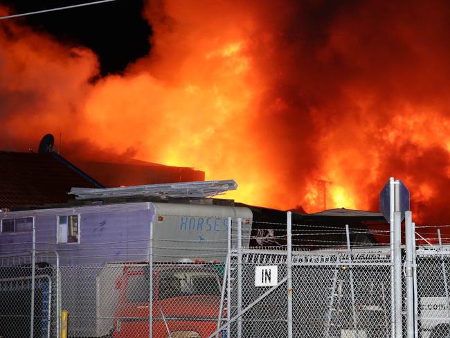 Fire has destroyed a storage complex on Burrows Road, Alexandria. Flames were seen rising 30 metres into the air with explosions heard coming from within. Reports there were motorcycles and spare parts stored in one of the three buildings destroyed. Pics Bill Hearne