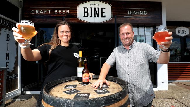 Bine Bar Mermaid Beach Manager Scott Imlach with staff member Jenna Cook clink to a ‘cheers’ for eased Covid restrictions. Photo: Scott Powick