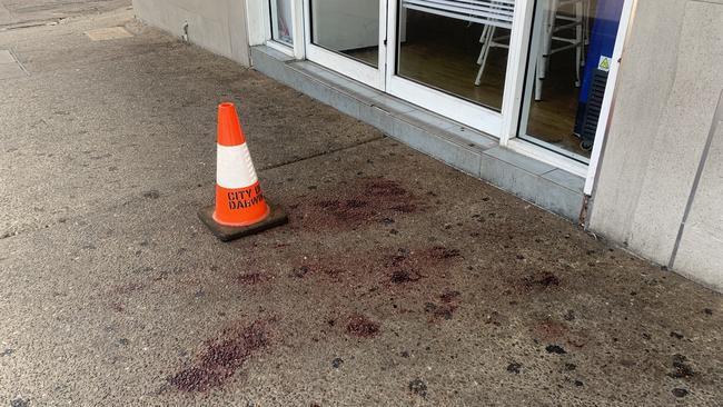 Blood spatter on the footpath on Mitchell St near the corner of Nuttall St in the Darwin CBD. A woman suffered serious injuries and was taken to Royal Darwin Hospital in a critical condition where she later died on December 20, 2022. Picture: Sierra Haigh